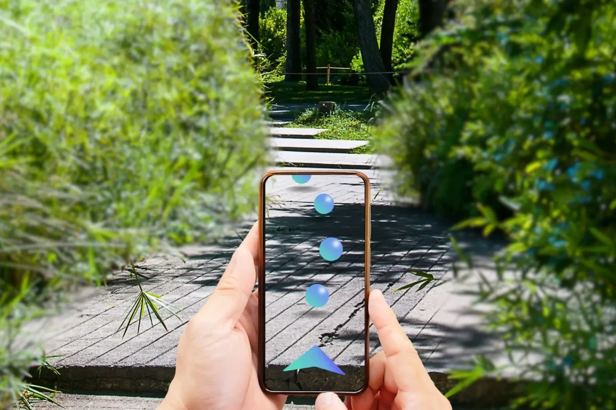 a person holding a cell phone in their hand while using AR Wayfinding